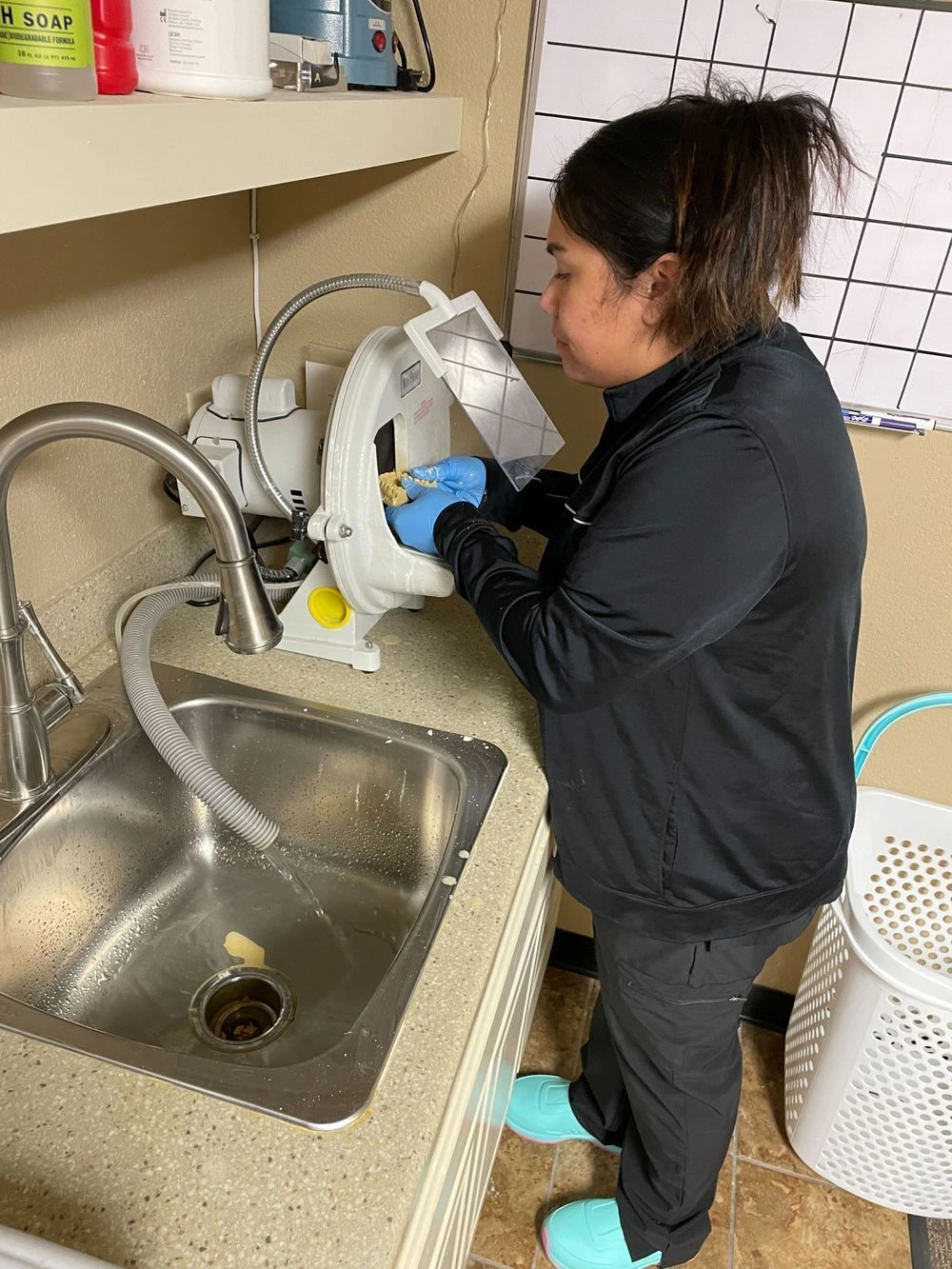 student examining a dental mold in the lab
